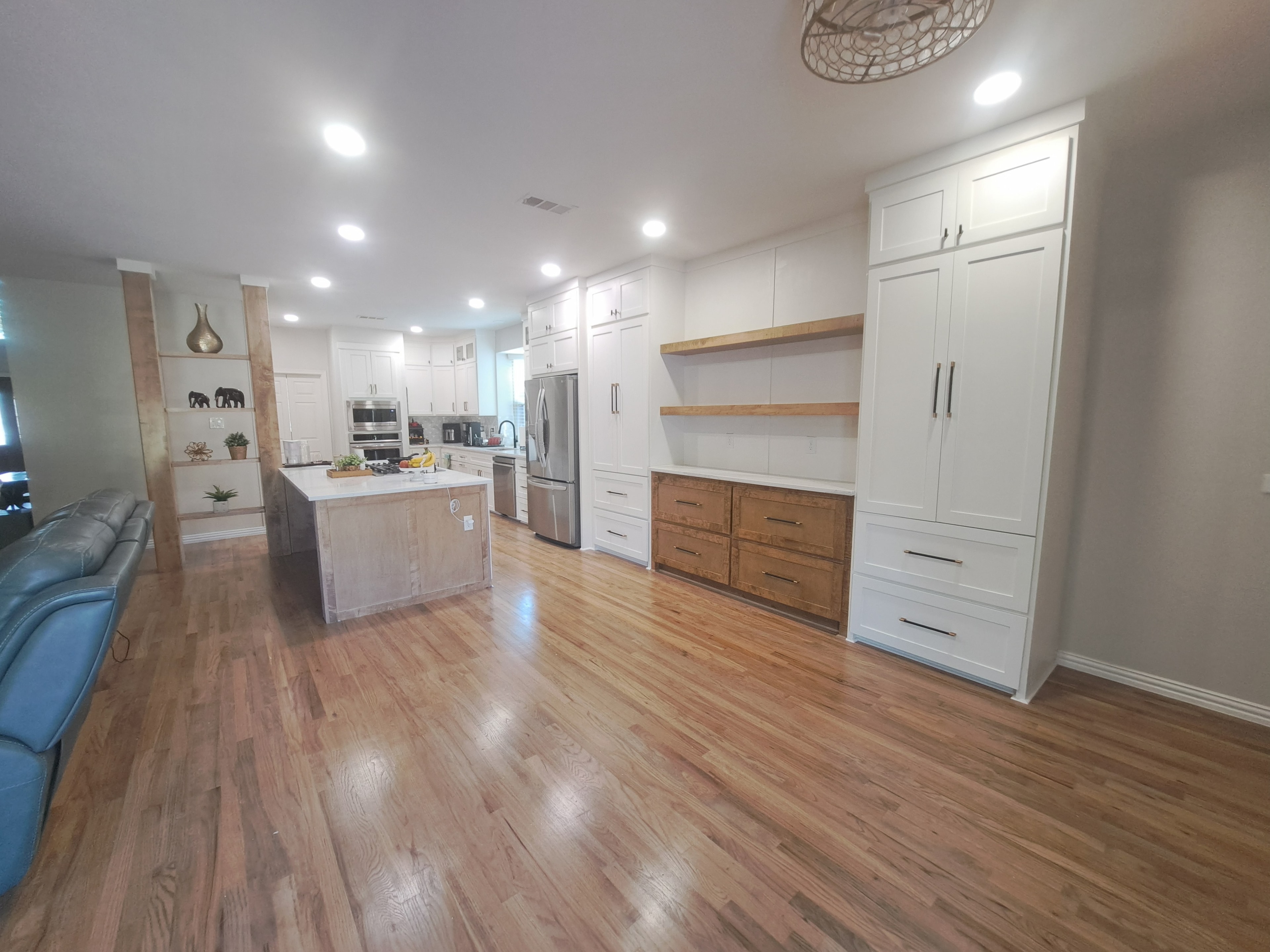 Completed kitchen remodel with two-tone shaker cabinets, quartz countertops, and hardwood flooring — Fort Worth, TX